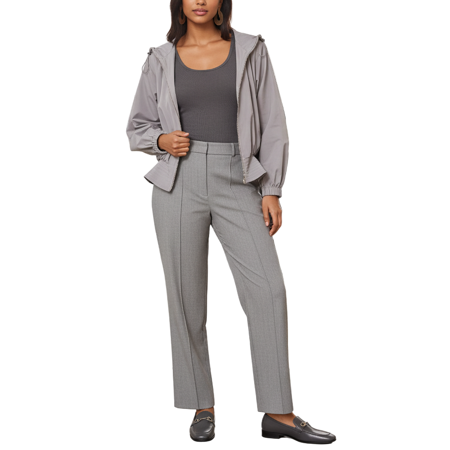 Woman in a gray suit standing in a modern office setting