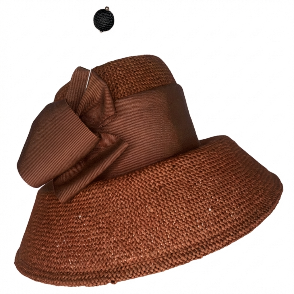 Brown straw hat with a large bow on a white background