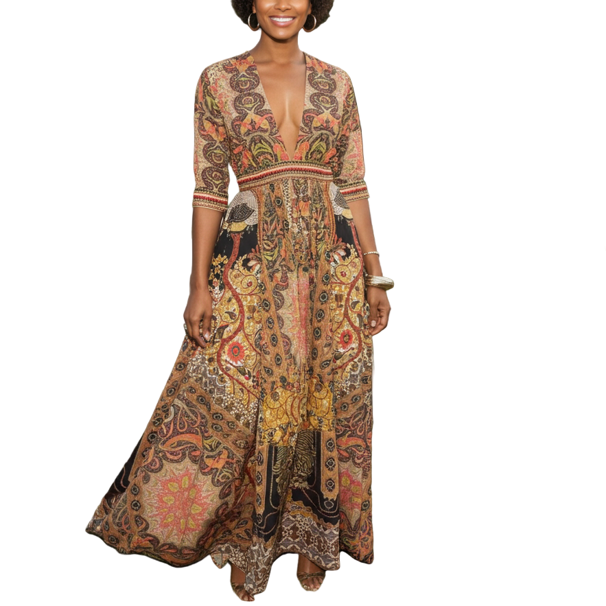 Woman in a patterned dress standing outdoors with white chairs and people in the background.