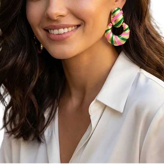 Woman wearing colorful earrings with a blurred outdoor background