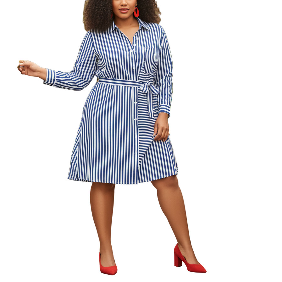 Woman in a blue and white striped dress standing in a garden with pink flowers.