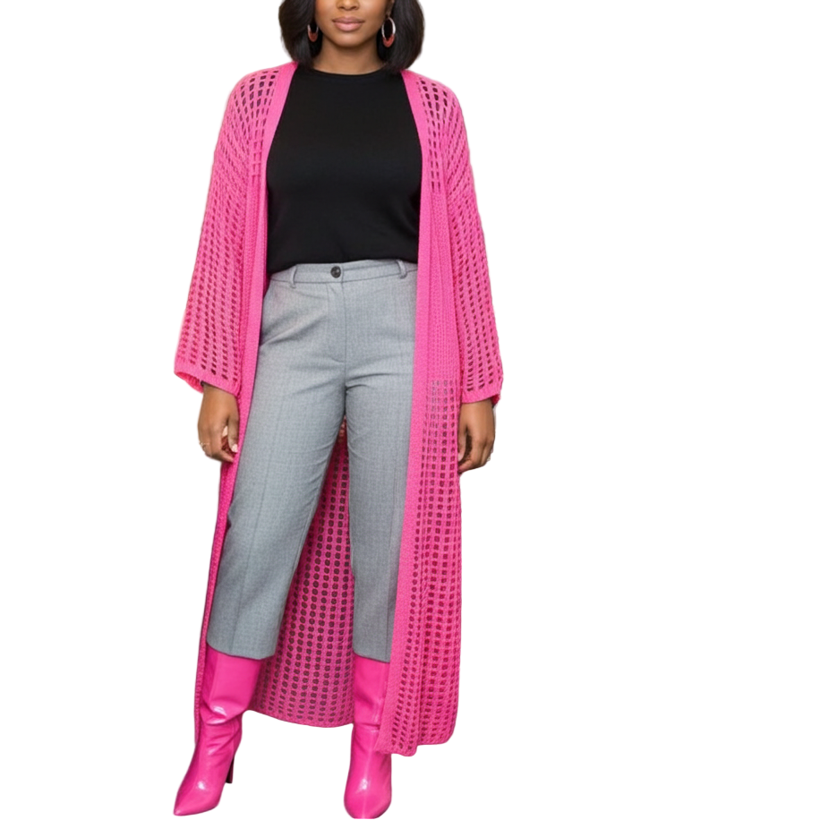 Woman in a pink cardigan and gray pants standing in an office setting