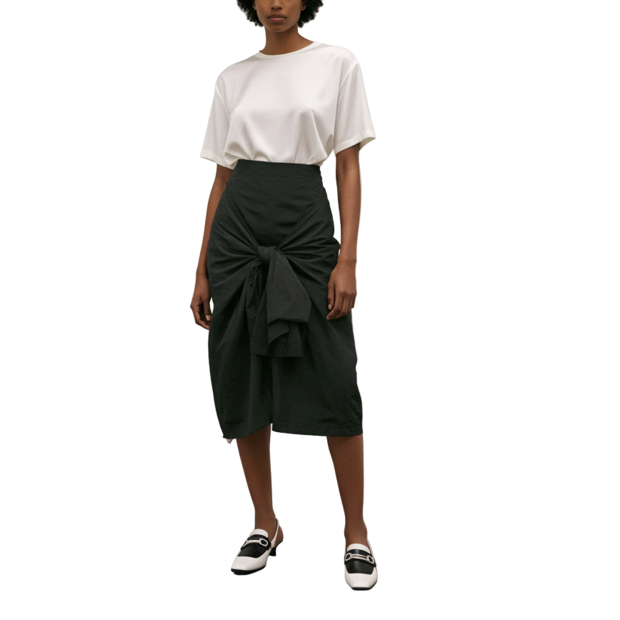 Woman standing in an art gallery with two paintings on the wall.