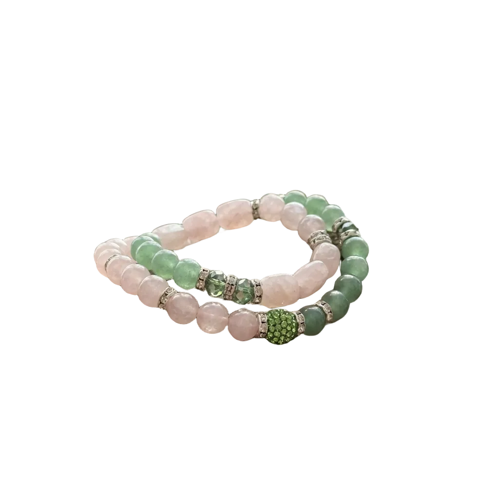 Three beaded bracelets on a piece of driftwood with a natural background