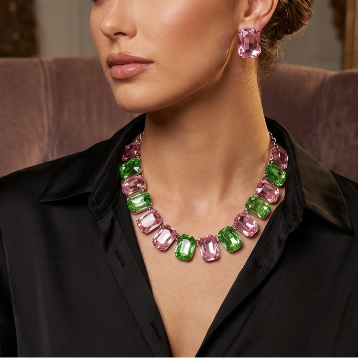 Woman wearing a colorful gemstone necklace and earrings in an elegant setting.
