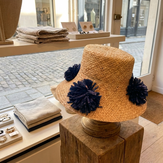 Natural Straw Hat with Navy Blue Pom Pom Detail