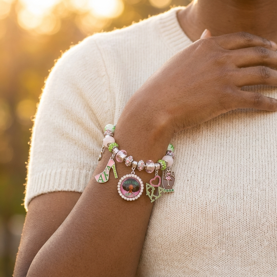 Alpha Kappa Alpha adjustable multi-charm bracelet with enamel AKA charms and pink and green crystal beads.
