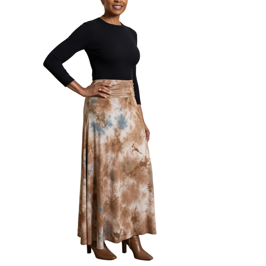 Woman in a black top and tie-dye skirt standing in an art gallery.