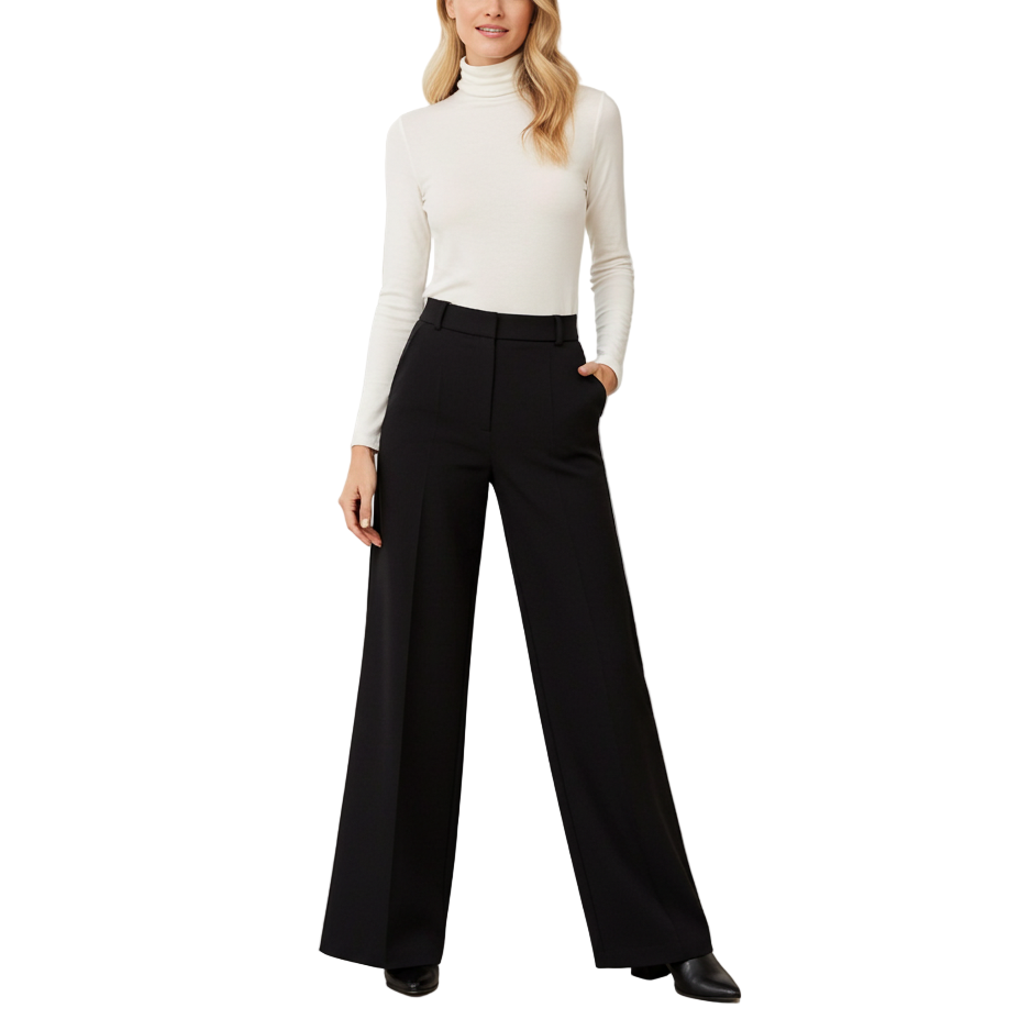 Woman wearing a white turtleneck and black wide-leg pants in a minimalistic room.