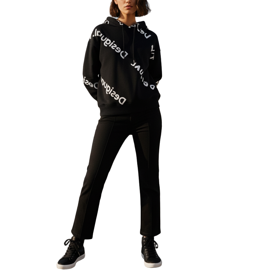 Person wearing a black hoodie with white text on a rooftop with cityscape in the background