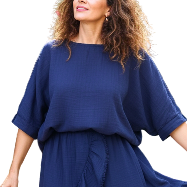 Woman in a blue dress standing in a garden with pink flowers