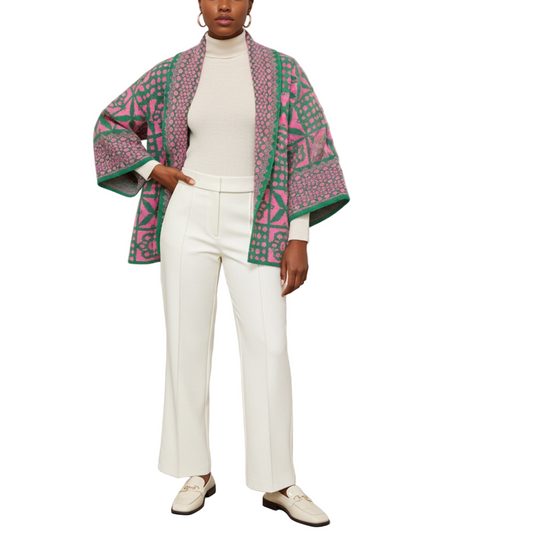 Person wearing a colorful patterned coat in an art gallery setting