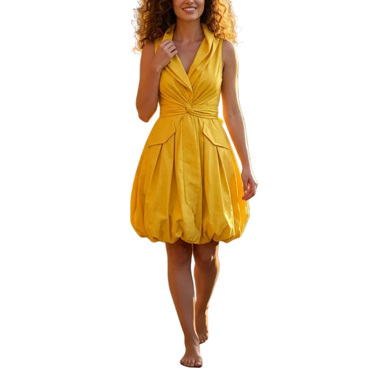 Woman in a yellow dress walking on a stone path in a garden setting