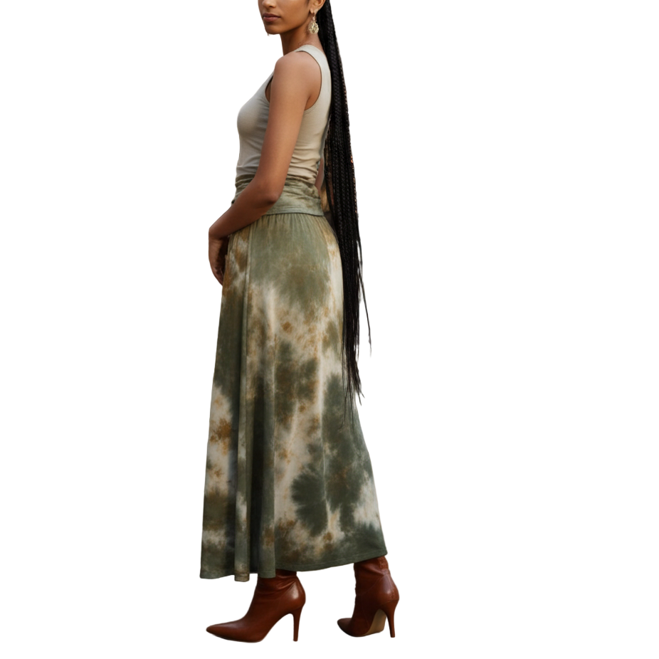 Woman in a tie-dye skirt standing in front of a fountain