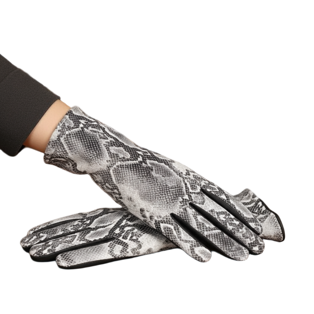 Snakeskin-patterned gloves on a wooden surface with books in the background