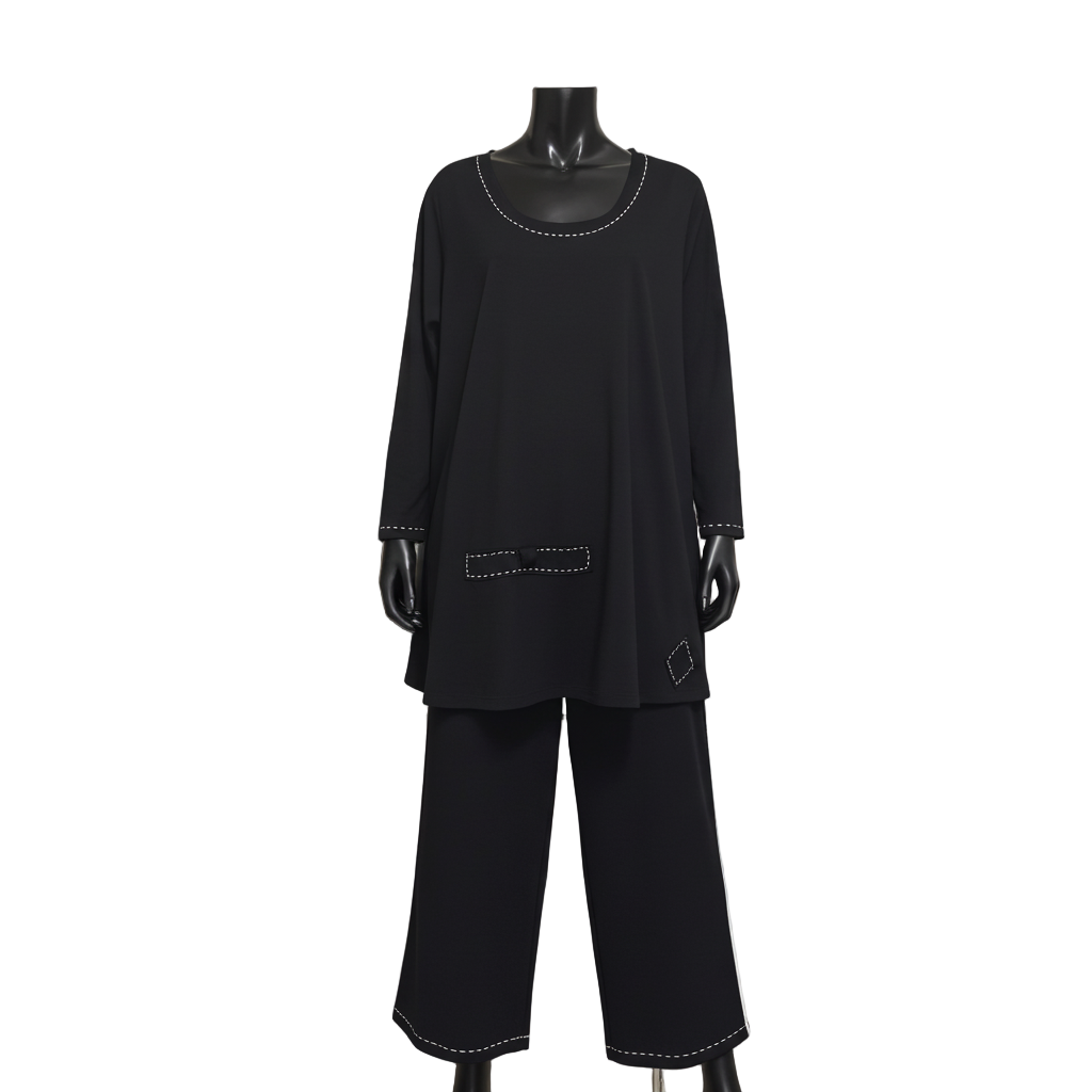 Black outfit on a mannequin in a clothing store setting with racks of clothes and mirrors in the background.