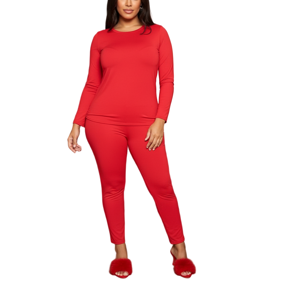 Woman in a red outfit standing in a modern living room.