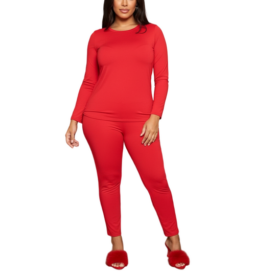 Woman in a red outfit standing in a modern living room.