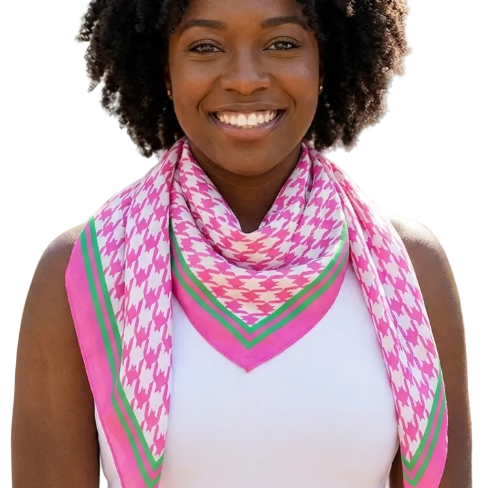 Woman wearing a pink and green patterned scarf outdoors