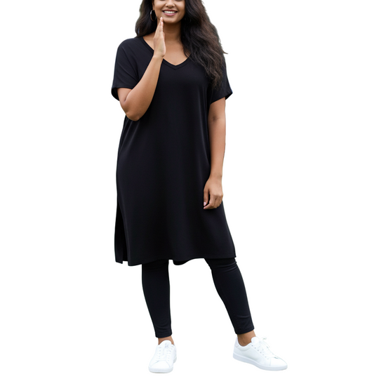Woman in black outfit on a tennis court with spectators in the background