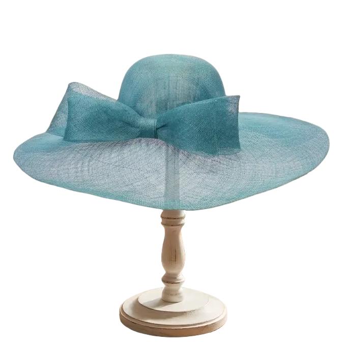 Blue sun hat on a stand with colorful scarves and sunglasses on a wooden table in a clothing store.