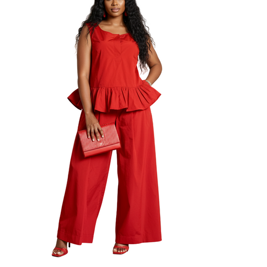 Woman in a red outfit standing in an art gallery