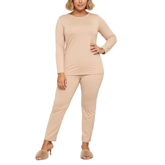 Woman wearing a beige loungewear set in a modern living room.