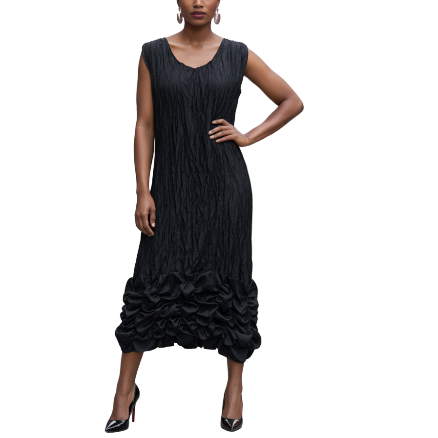 Woman in a black sleeveless dress standing on a city street.