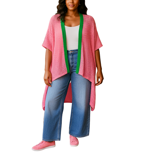 Woman in a pink kimono-style garment standing in a casual dining setting.