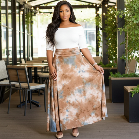 Woman wearing a white top and patterned skirt in an outdoor setting