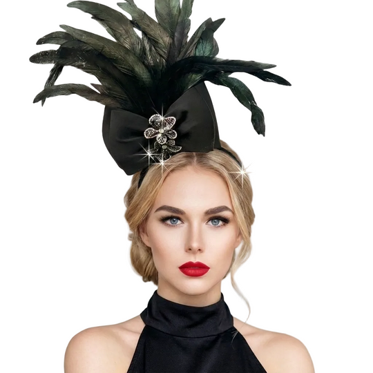 Woman wearing a black feathered headpiece with a bow on a gray background