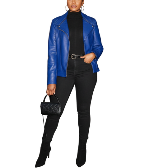 Woman in a blue leather jacket and black outfit standing outside a building.