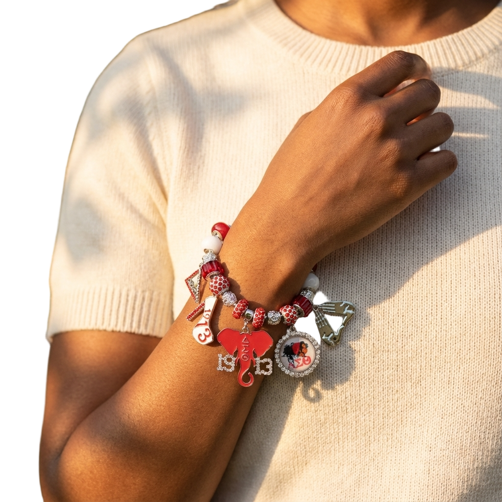 Delta Sigma Theta silver-tone adjustable charm bracelet with enamel DST symbols and red and white crystal beads.