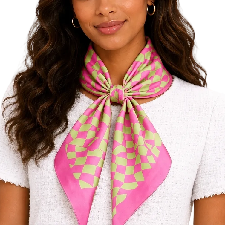 Woman wearing a pink and green patterned scarf on a plain background