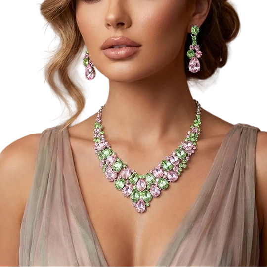 Woman wearing a green and pink gemstone necklace and earrings in an elegant setting.