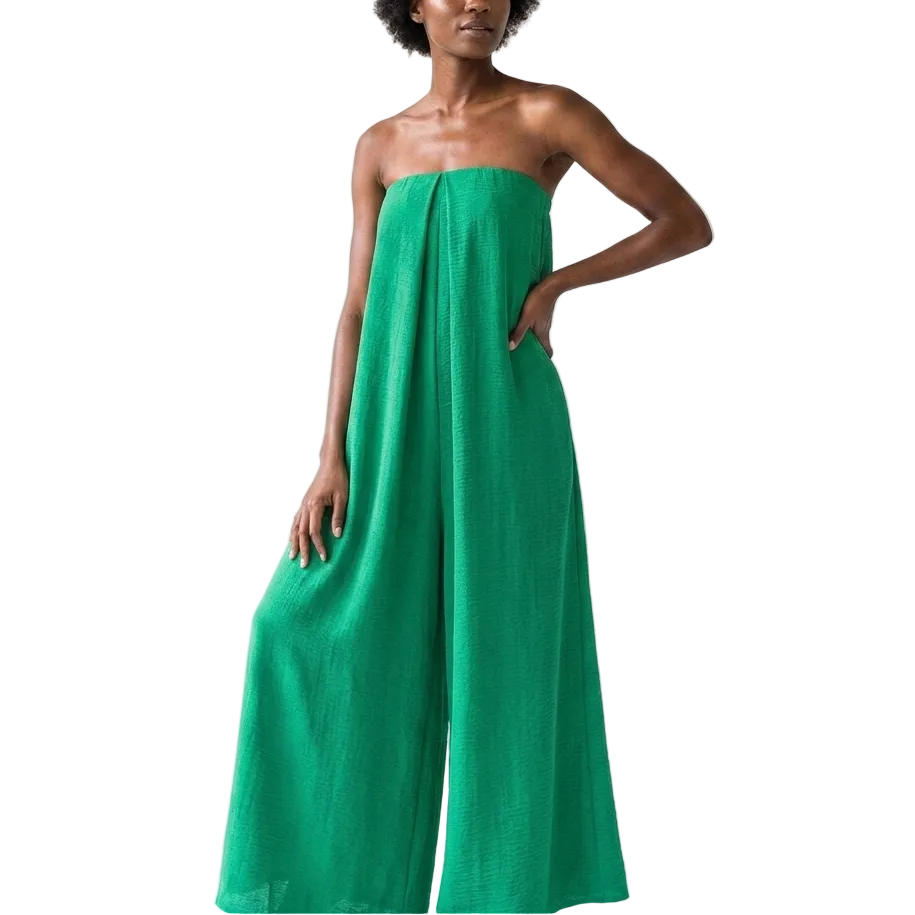 Woman wearing a strapless green jumpsuit on a white background