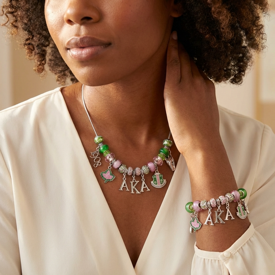 Woman wearing a necklace and bracelet with 'AKA' charms on a neutral background