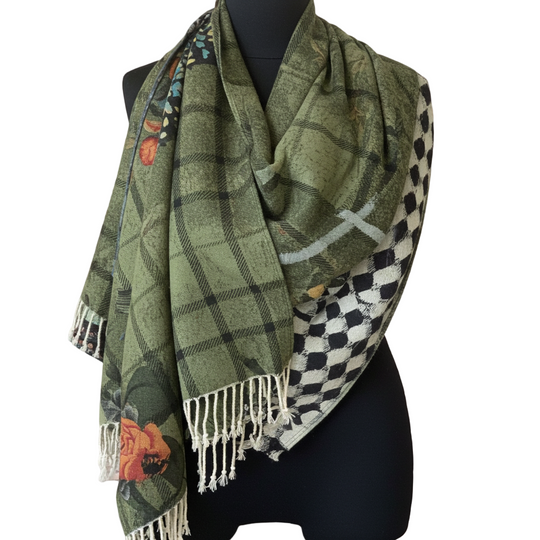 Green plaid scarf with floral patterns draped over a mannequin in a store setting.