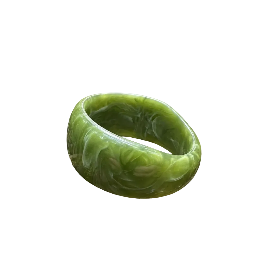 Green bracelet on a mossy log with a forest background