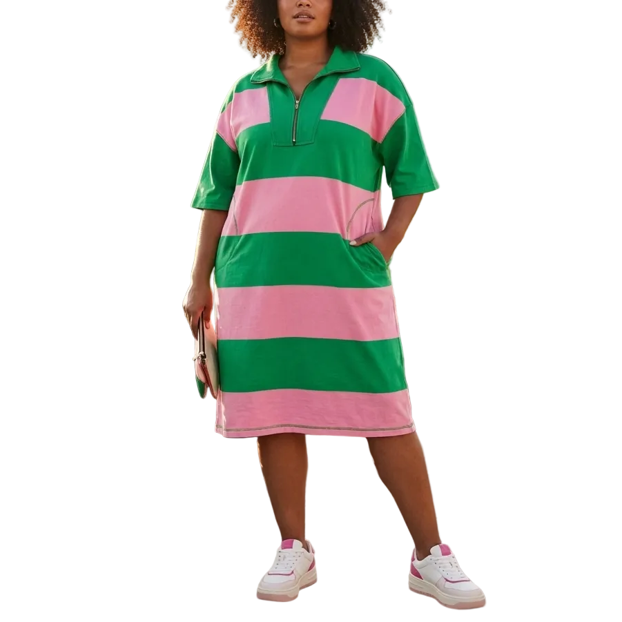 Woman wearing a green and pink striped dress on a rooftop with cityscape background