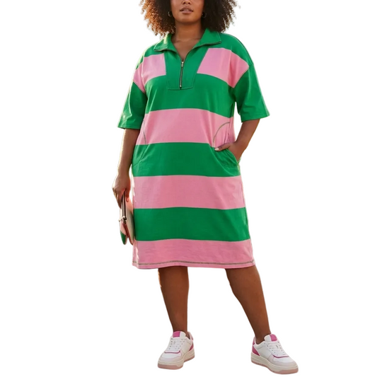 Woman wearing a green and pink striped dress on a rooftop with cityscape background