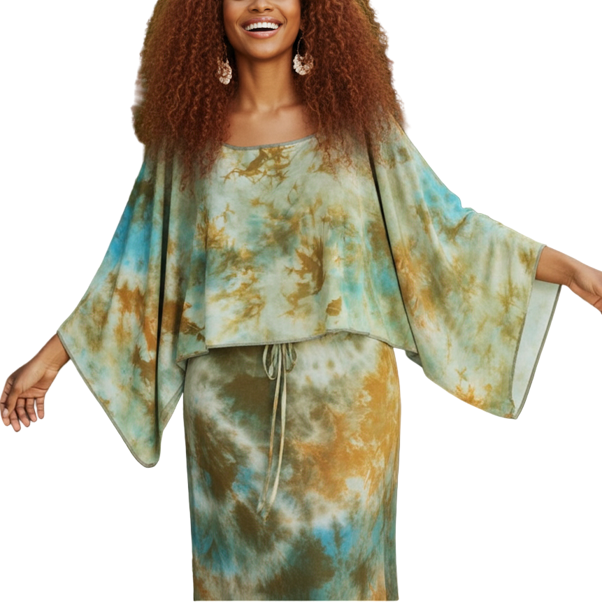 Woman in a tie-dye outfit standing among tropical plants