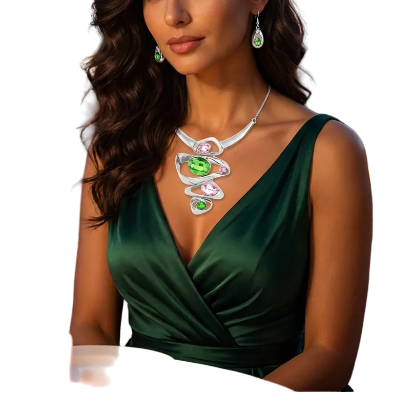 Woman in a green dress with a necklace, sitting at a table with a candle and flowers, against a cityscape background.