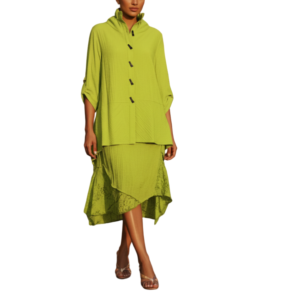 Woman in a green outfit standing on a cobblestone street.