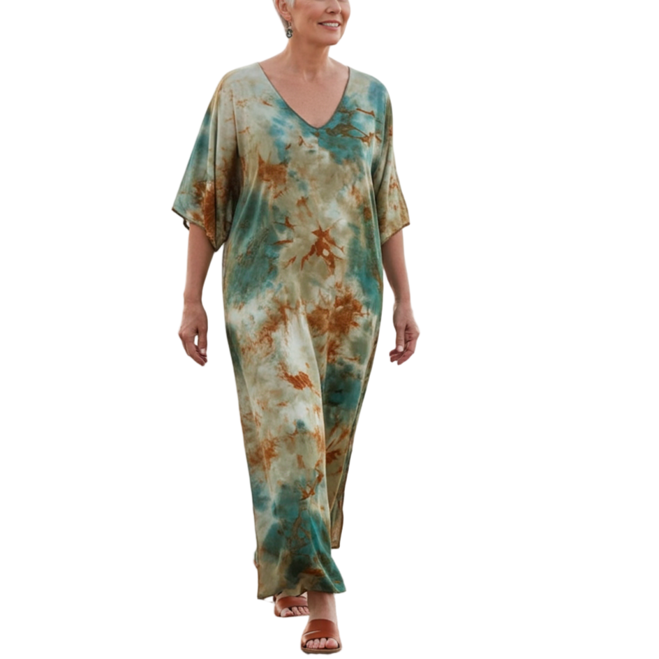 Woman in a tie-dye dress walking on a beach
