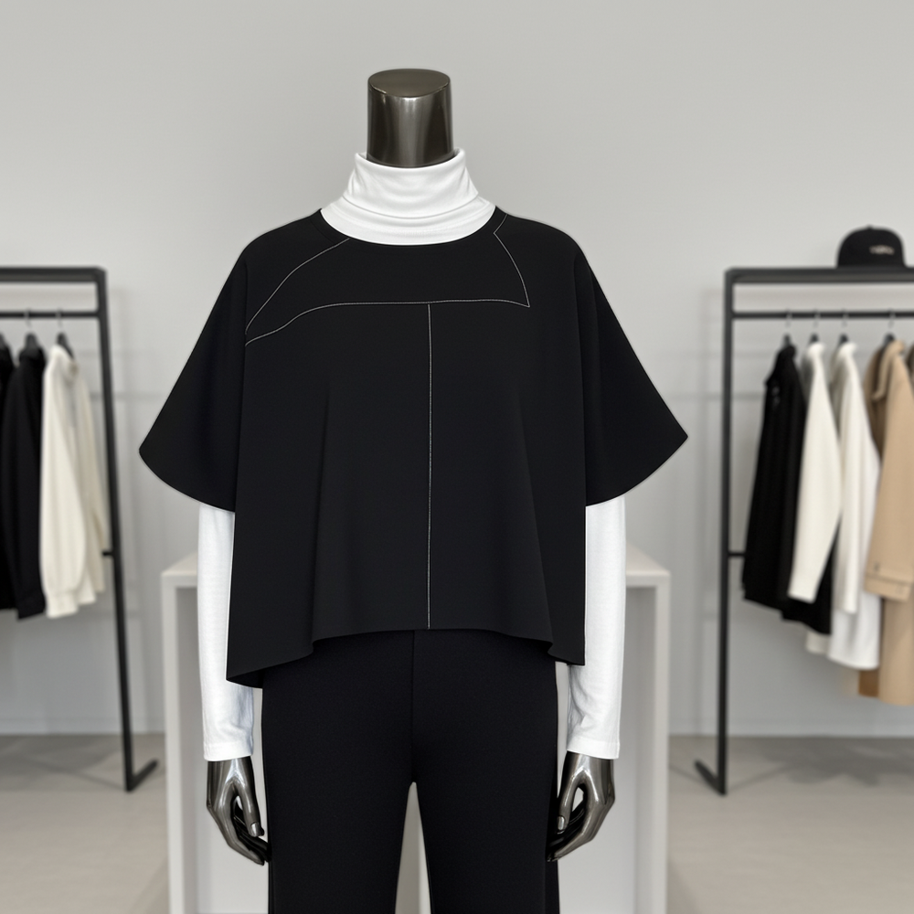Mannequin wearing a black outfit with a white turtleneck in a clothing store setting.