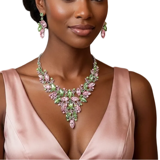Woman wearing a pink dress and green and pink jewelry in an elegant indoor setting