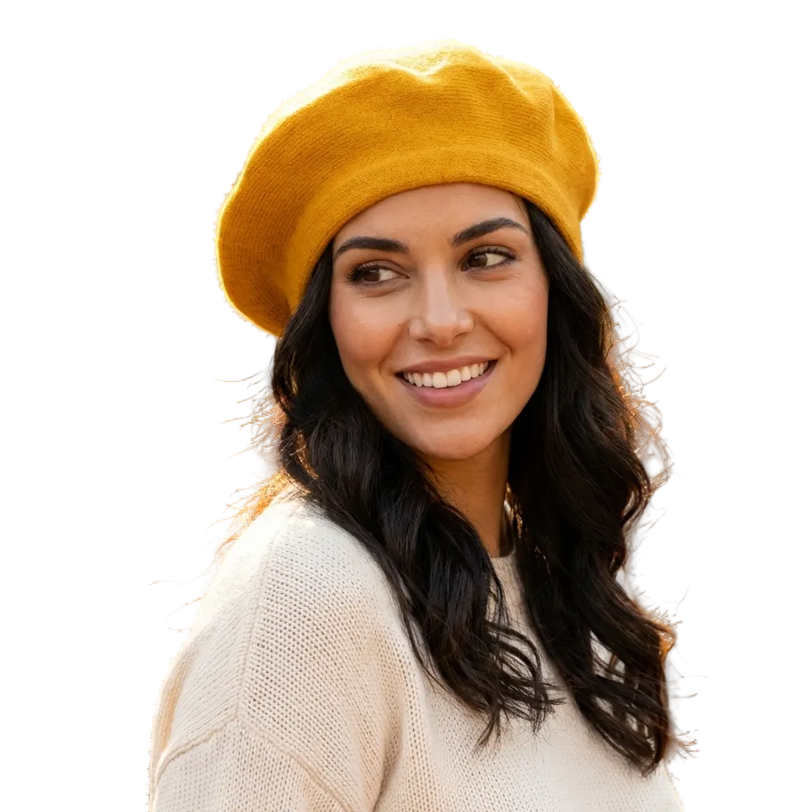 Woman wearing a yellow beret and beige sweater outdoors with blurred background