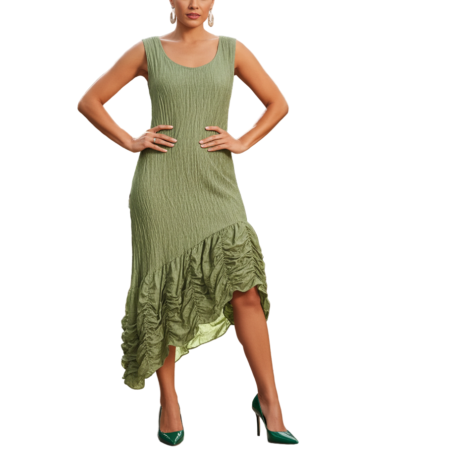 Woman in a green dress standing in a greenhouse with plants and a fountain in the background.