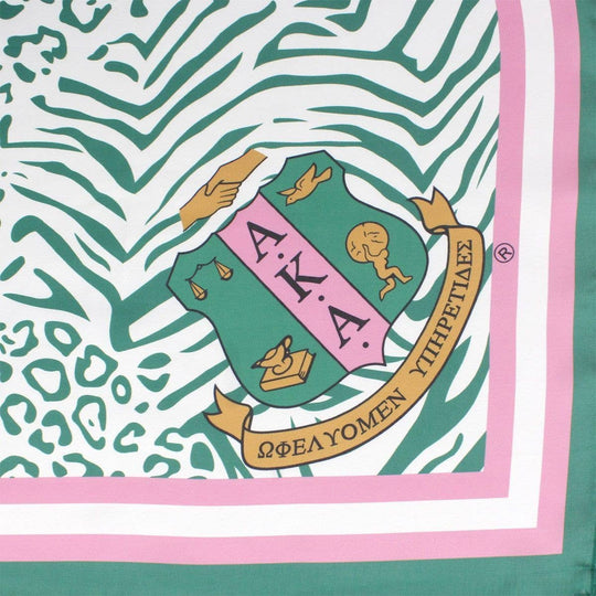 AKA Sorority scarf in green, white, and pink animal print with stripe edging, letters, and shield corners.
